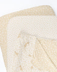 Love Cats bedside crib starter pack featuring matching fitted sheets and a reversible coverlet on a white background
