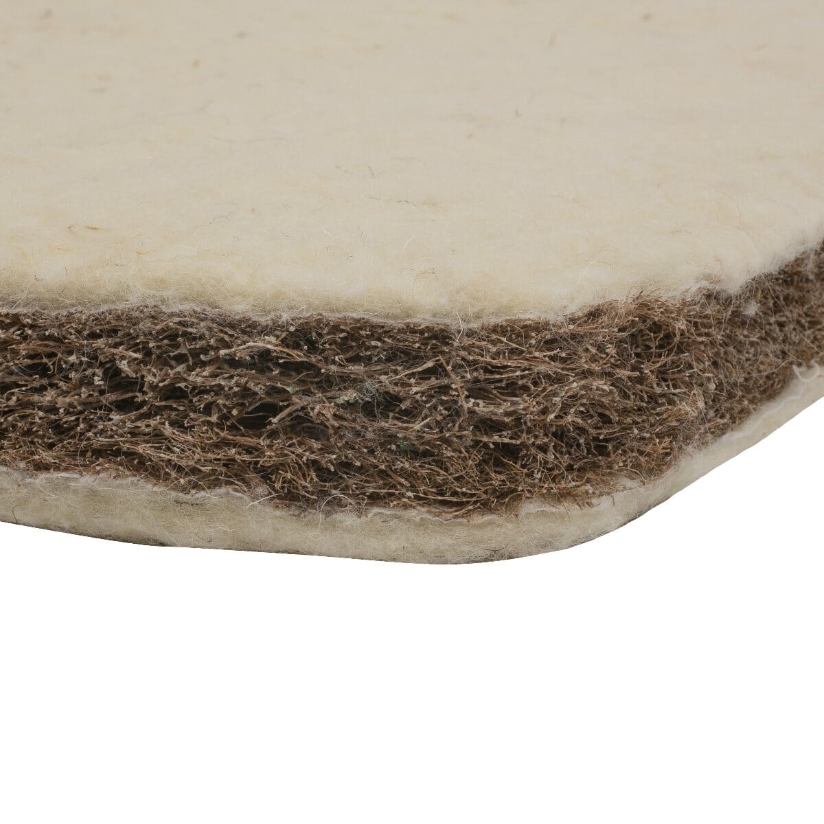 Close-up view of the CoZee mattress showing natural wool layers and breathable coir fibre core for firm, supportive comfort.