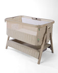 CoZee Sense beige baby crib with mesh and quilted lining sides, storage and sensory bar on a white background