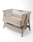 CoZee Sense beige baby crib with mesh and quilted lining sides, storage and sensory bar on a white background