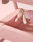 cozee air 2 in blush showing toy being placed in the spacious underneath storage