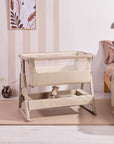 Side view of the CoZee Air 2 in cocoa styled in a bedroom setting, showcasing rocking legs, storage basket and soft neutral design.
