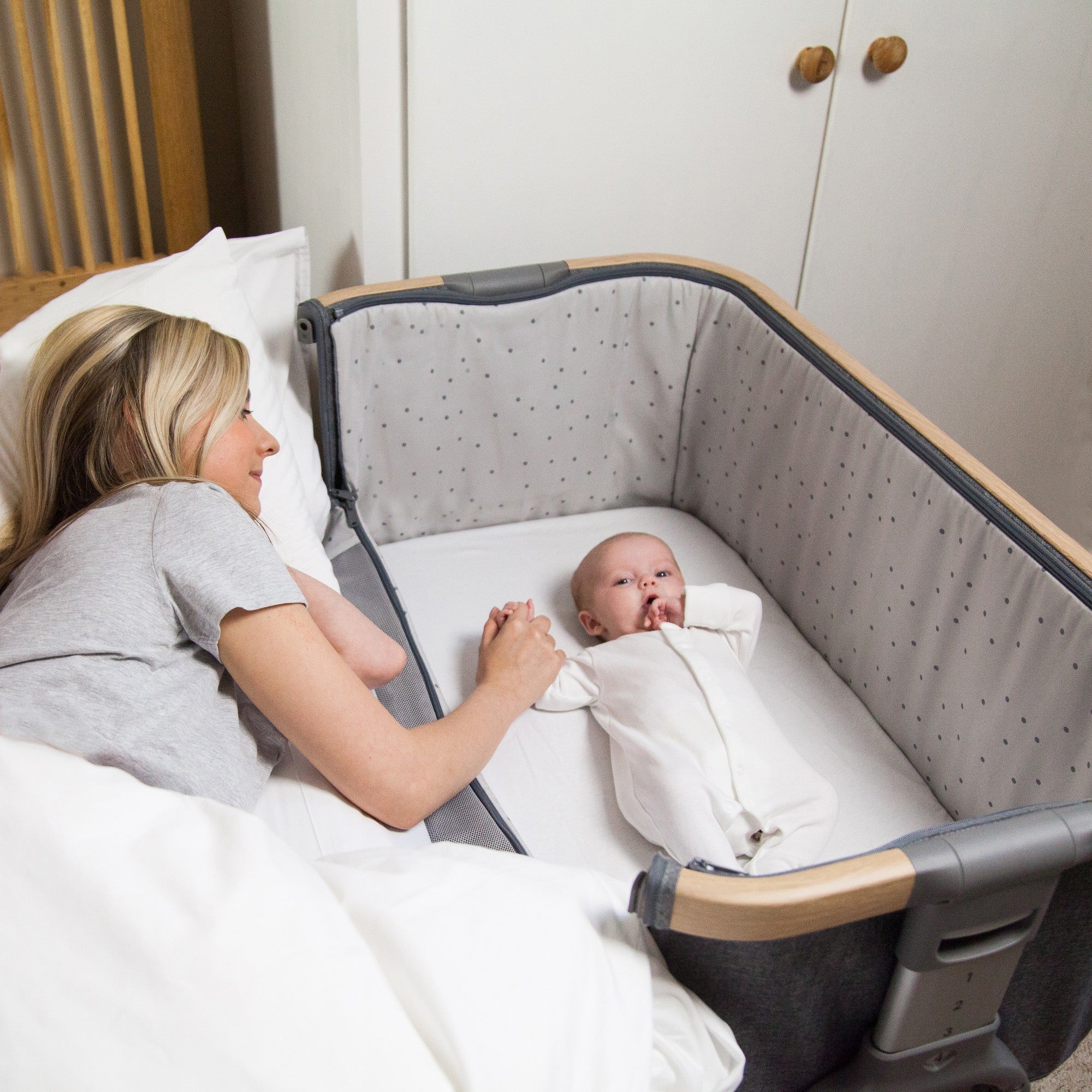 CoZee Bedside Crib in Oak and Charcoal - side-sleeping feature for easy nighttime bonding and access