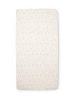Cocoon cot bed sheets with a flower print in beige and grey tones