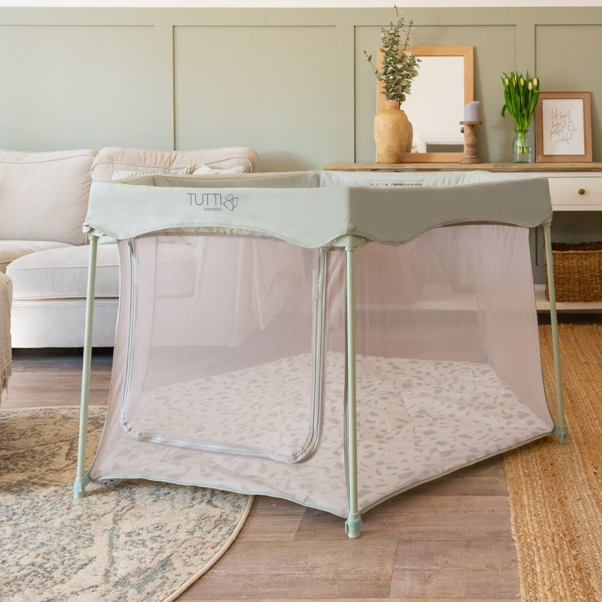Room view of the Hexa playpen in Leaf Terrazzo featuring breathable mesh sides, zip-open door, and padded terrazzo print playmat