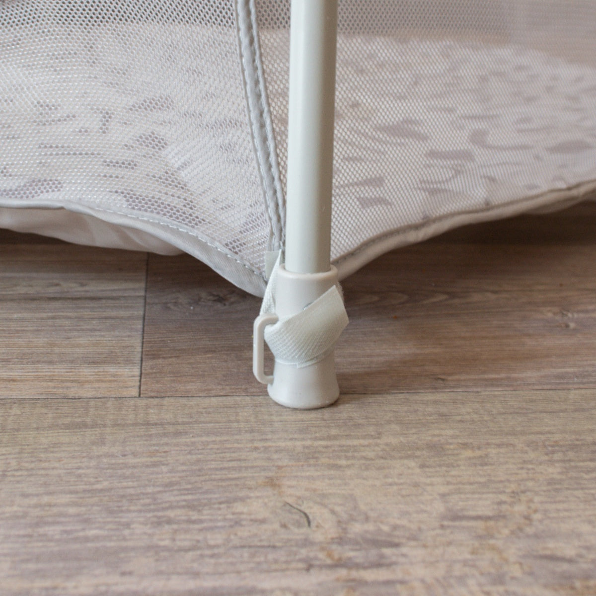 Close-up view of Hexa Playpen leg in mushroom terrazzo, showing secure floor grip and strap fastening for added frame stability