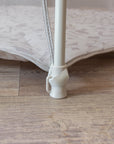 Close-up view of Hexa Playpen leg in mushroom terrazzo, showing secure floor grip and strap fastening for added frame stability