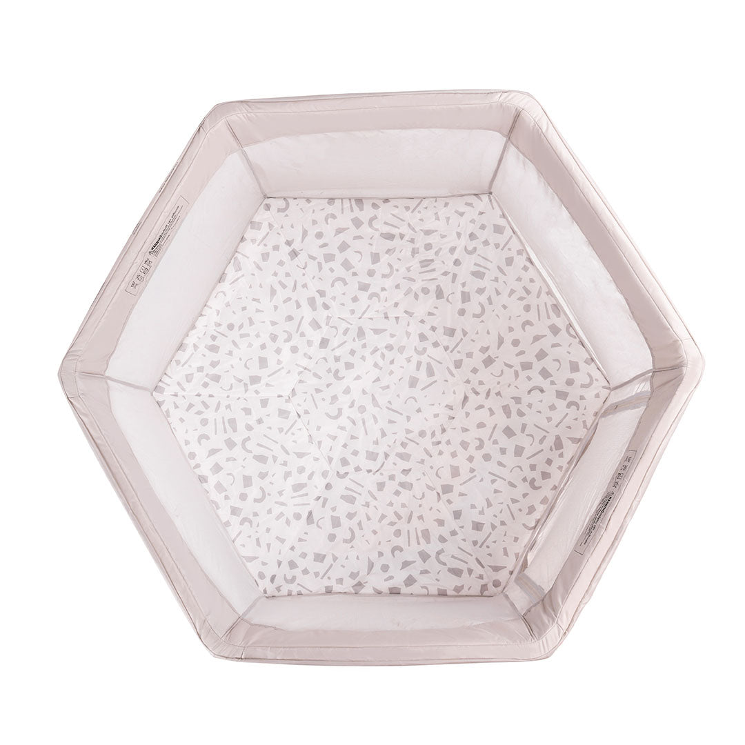 Overhead view of the Hexa Playpen in Mushroom Terrazzo, showing soft padded base with playful terrazzo pattern and mesh sides