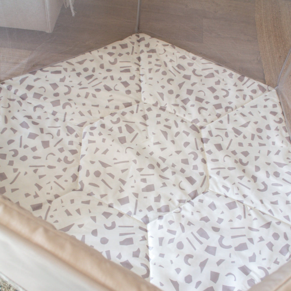 Overhead view of the Hexa Playpen in mushroom terrazzo, highlighting soft padded playmat with abstract mushroom-coloured shapes on white