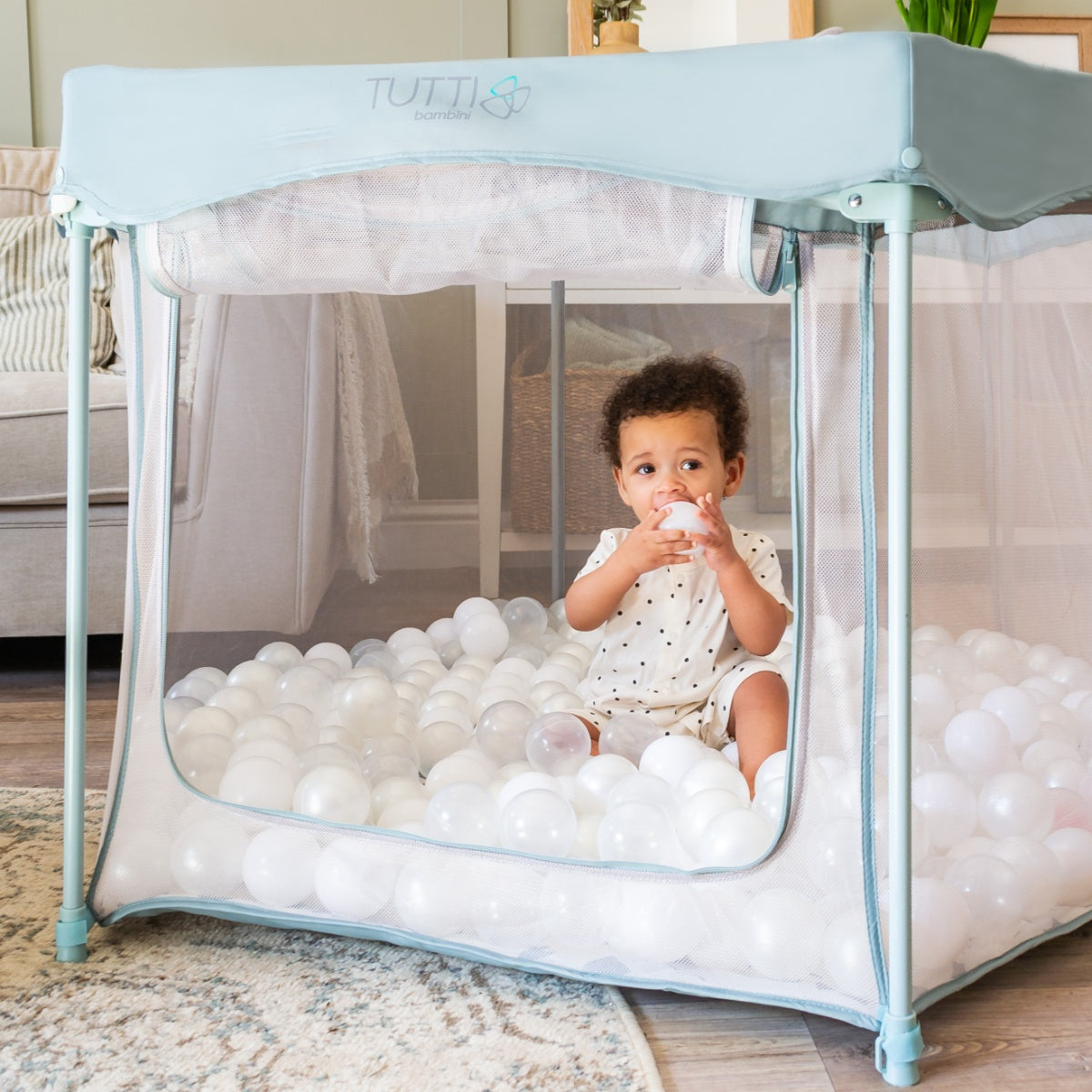 Room view of the Ocean Stone Terrazzo Hexa playpen with mesh walls and zip entry, offering a spacious, safe play space