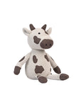 Plush cow toy on a white background.