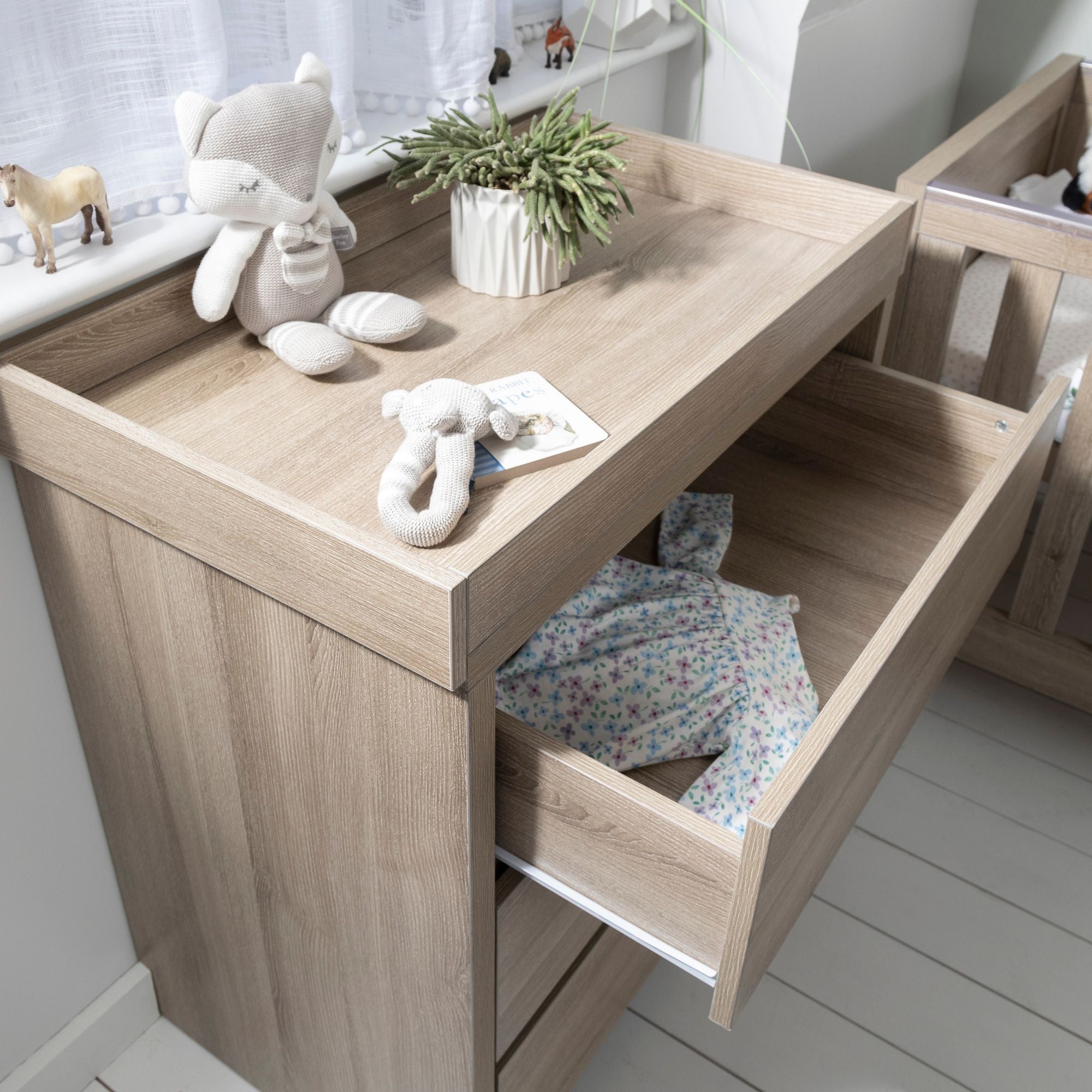 The Modena chest changer in oak offers a modern look with three drawers and a removable changer.