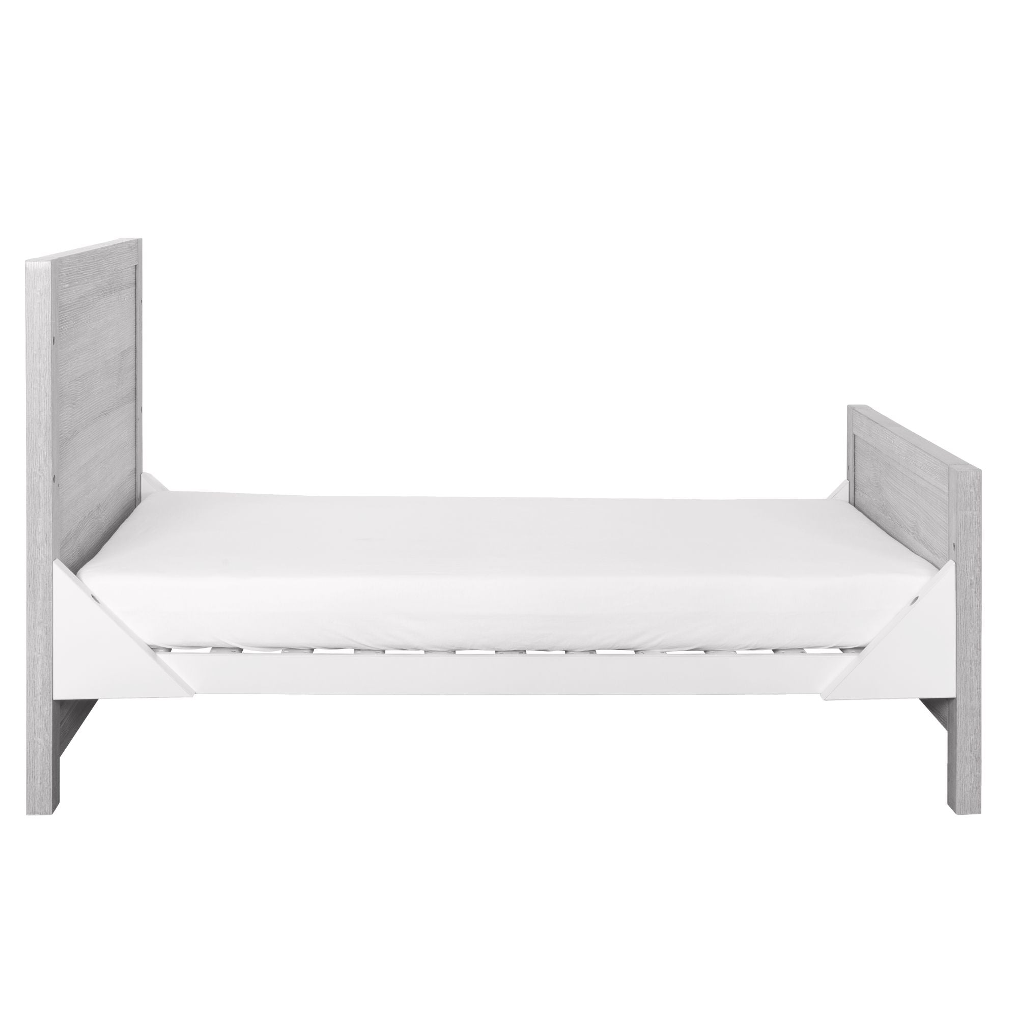 Modena Cot Bed in Grey Ash and White displayed in toddler bed configuration with safety sides removed, offering an open and easy-access sleep space.