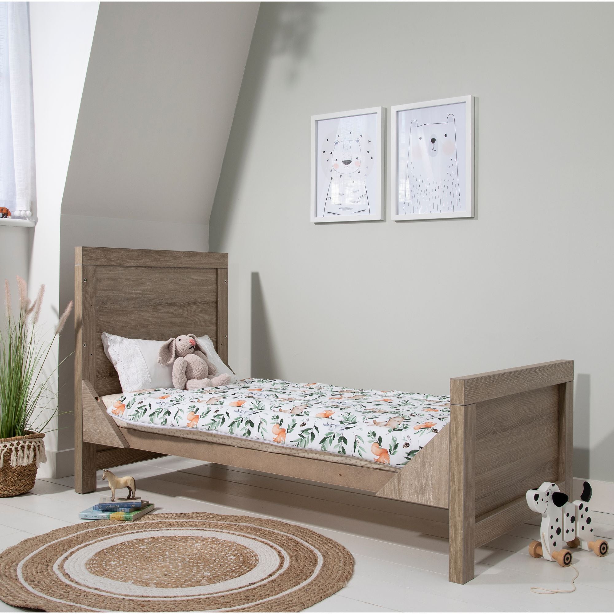Modena Cot Bed in Oak converted into a toddler bed, creating a stylish and practical sleeping space for growing children.