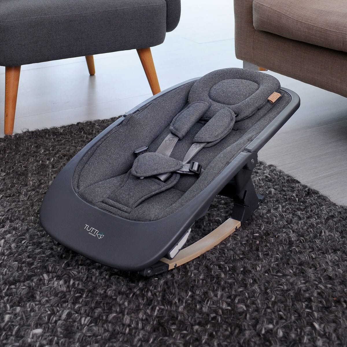 Nova rocker in grey oak set up in a home setting, demonstrating its contemporary design and calming rocking motion for newborn comfort.