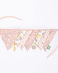 Tiny Tails pink floral nursery bunting with mixed patterned triangular flags and fabric ties, styled as a decorative garland.
