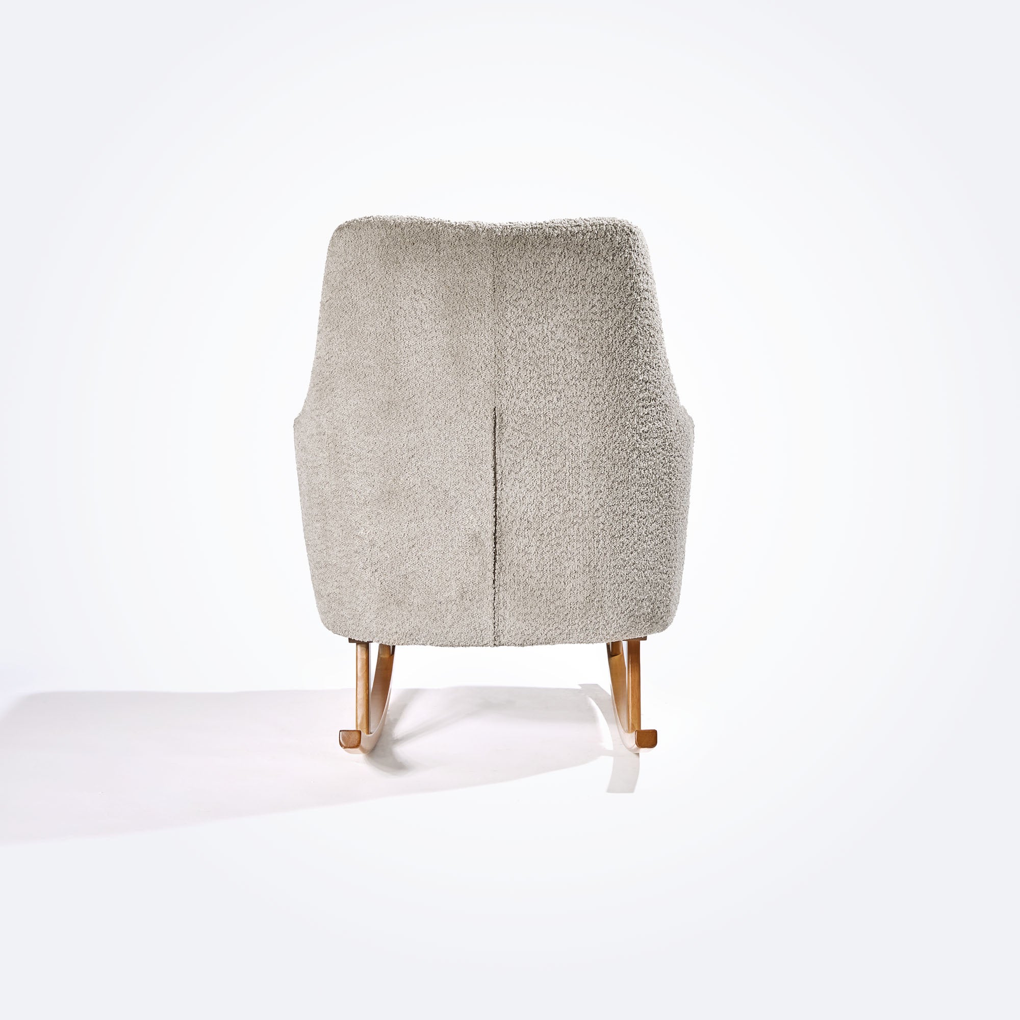 Rear cutout view of the Oscar Luxe rocking chair in teddy mushroom finish, showcasing its tall backrest, soft curves, and boucle texture