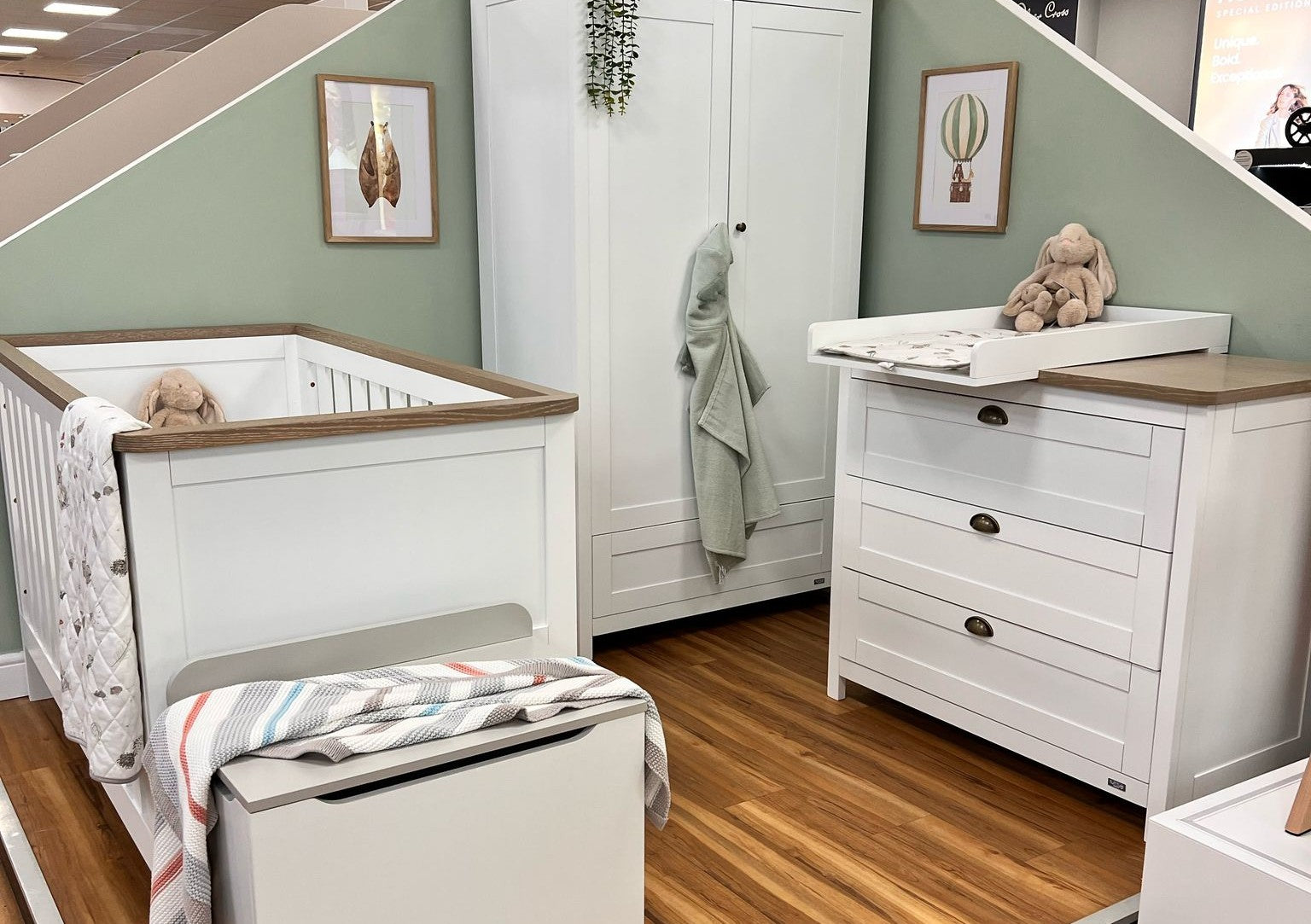 Nursery setting showing cot bed, chest changer and changing top