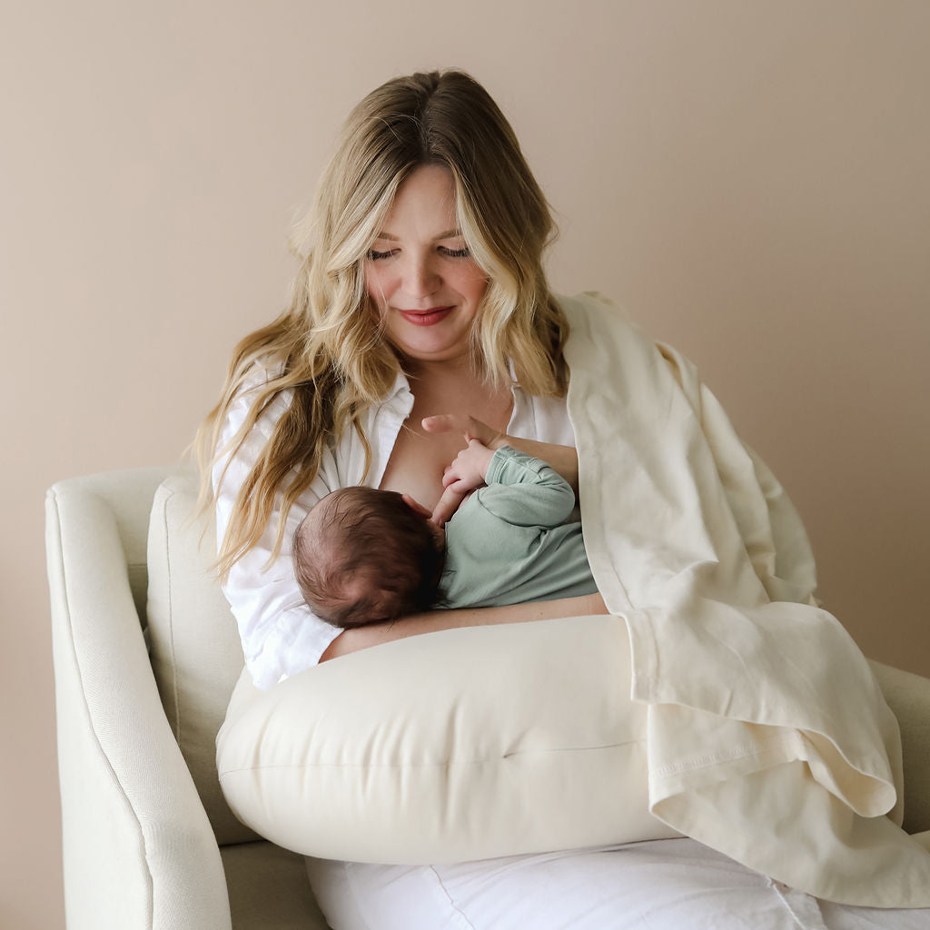 Mother breastfeeding baby using SMO nursing pillow in natural for comfort and support