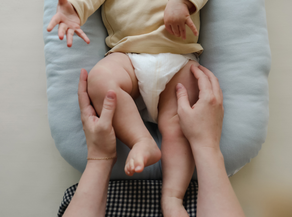 SMO Baby Lounger with a baby resting inside; machine washable and designed to feel like being held.