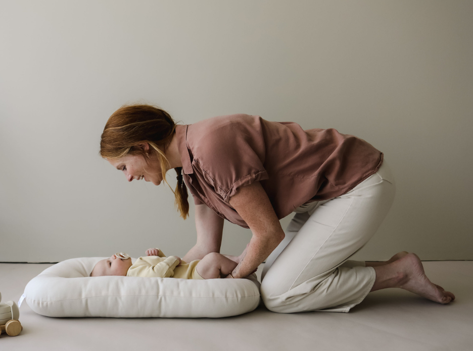 SMO Baby Lounger with baby resting inside, made from GOTS-certified organic materials for safe, gentle comfort.