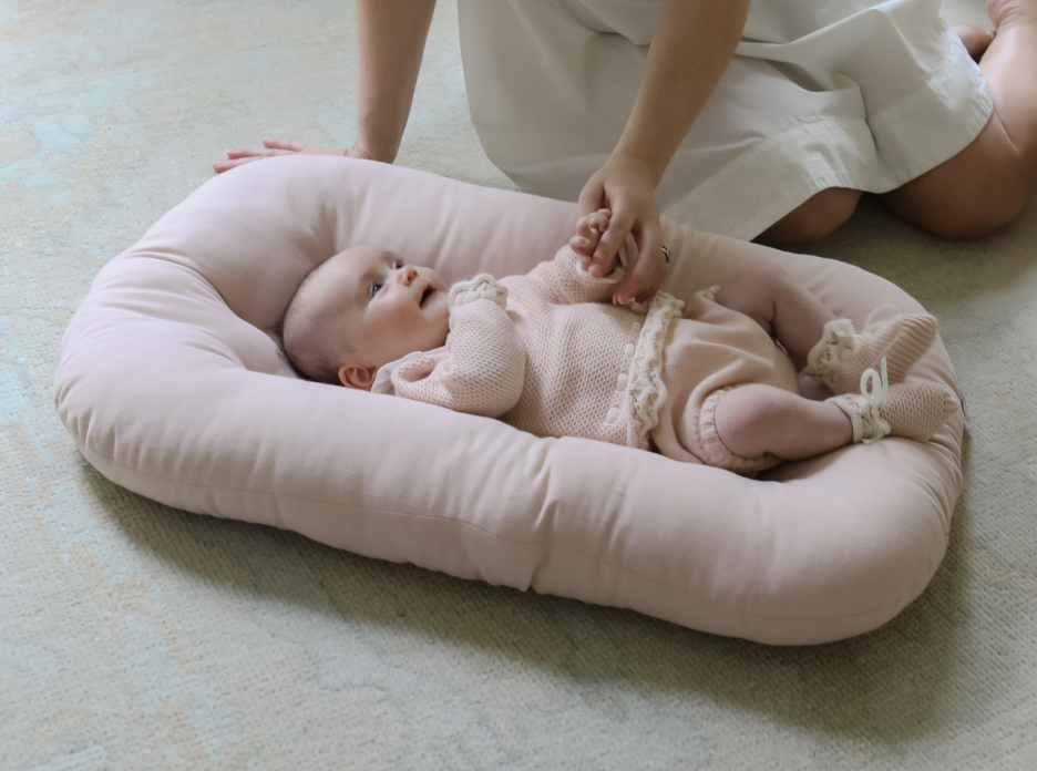 SMO Baby Lounger cradling a baby—like a second set of arms, offering comfort so you can rest.