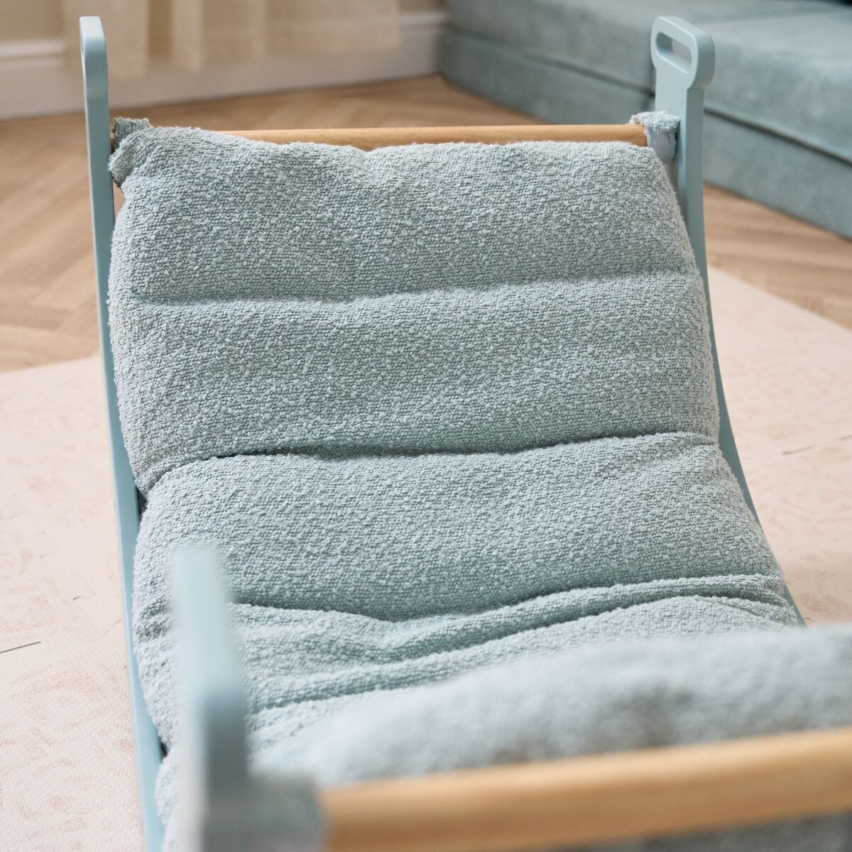 Scala Pikler cushion in boucle ocean stone, emphasising plush comfort and gentle ergonomic contouring.