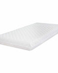 Angled view of sprung nursery mattress with quilted white cover and supportive foam-filled design for comfortable baby sleep.
