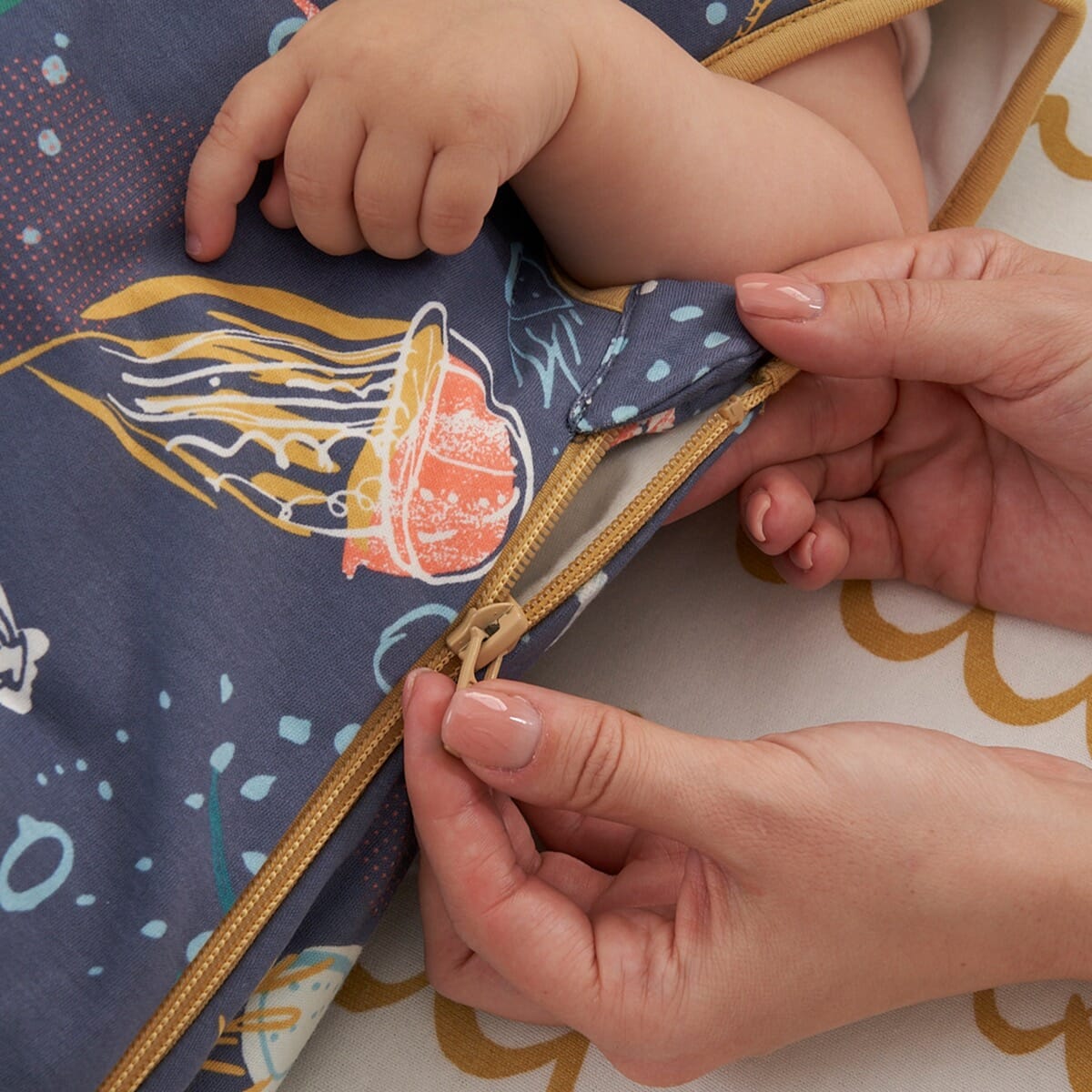 Close-up of zip fastening on Our Planet baby sleep bag, highlighting smooth, secure zip with protective cover for safe use.