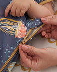 Close-up of zip fastening on Our Planet baby sleep bag, highlighting smooth, secure zip with protective cover for safe use.