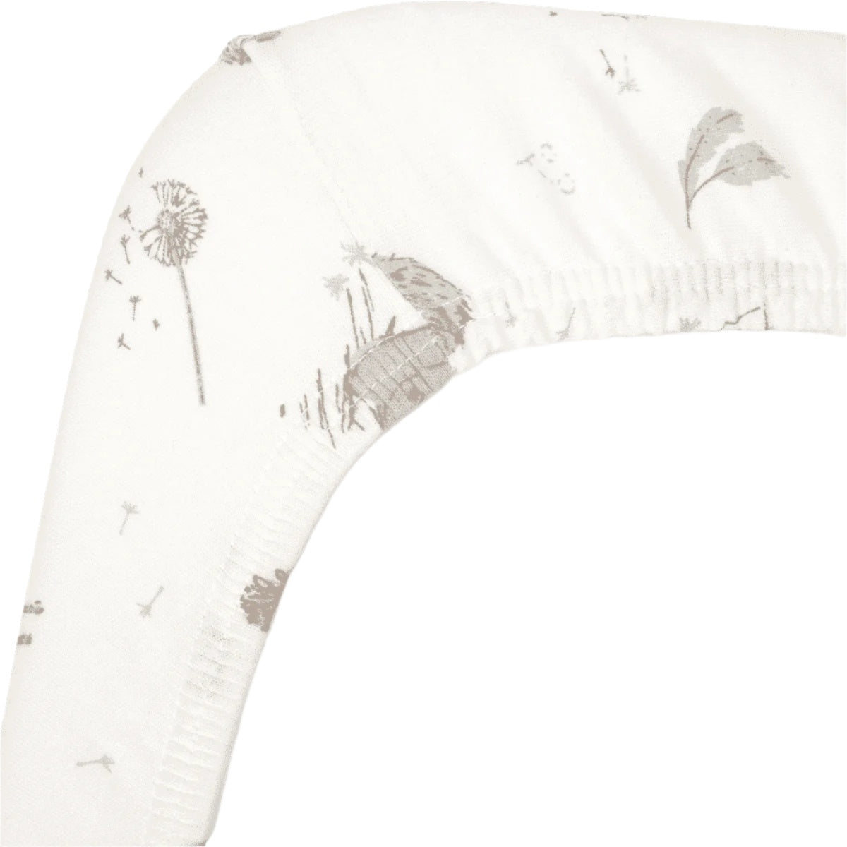 Close-up of Cocoon fitted sheet corner, highlighting soft organic cotton fabric, elasticated edge, and delicate dandelion-inspired detailing