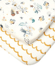 Close-up of Our Planet fitted sheets showing sea life and mustard wave prints in breathable organic cotton, designed for comfort and durability