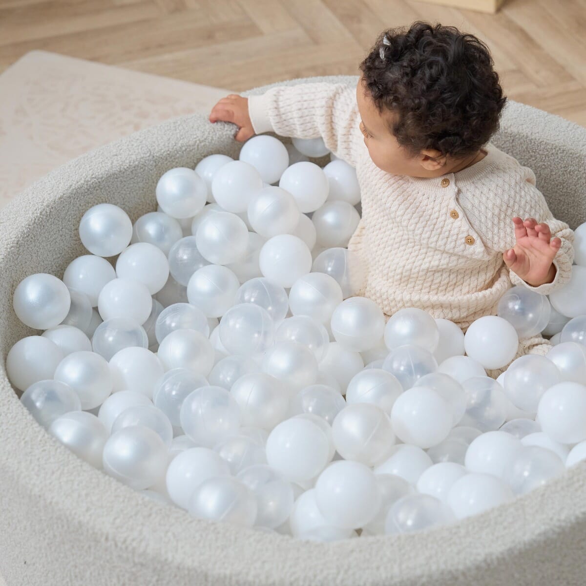 Bola Baby Ball Pit in Mushroom - lifestyle image of baby girl playing in the ball pit