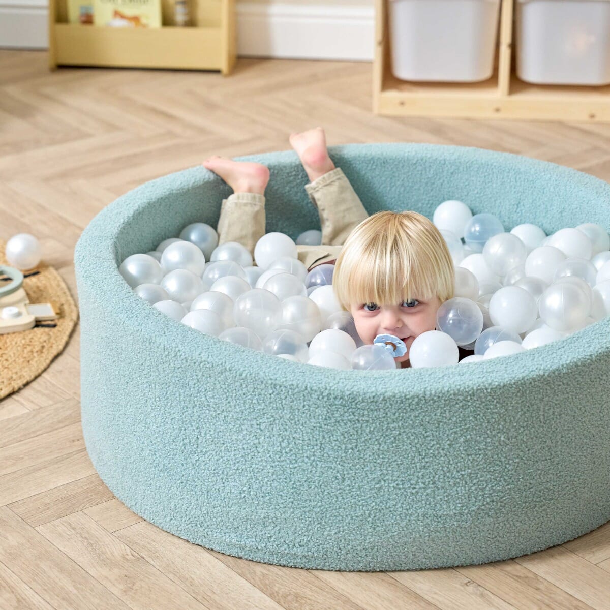 Bola Baby Ball Pit in Ocean Stone - lifestyle image of little boy playing in the ball pit