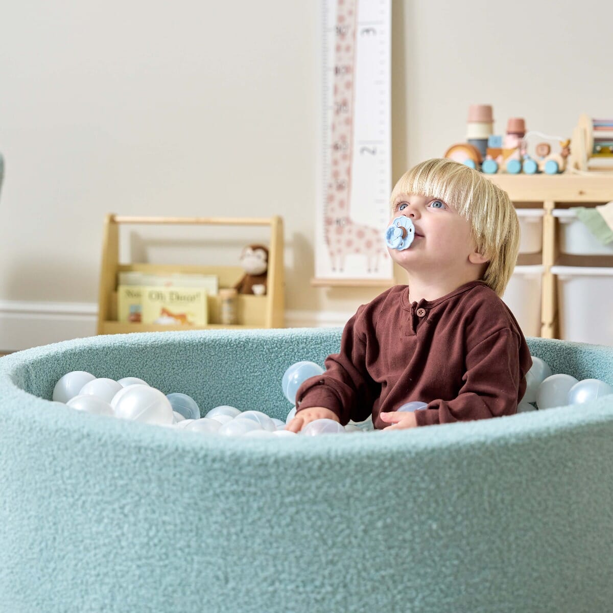 Bola Baby Ball Pit in Ocean Stone - lifestyle image of little boy playing the ball pit