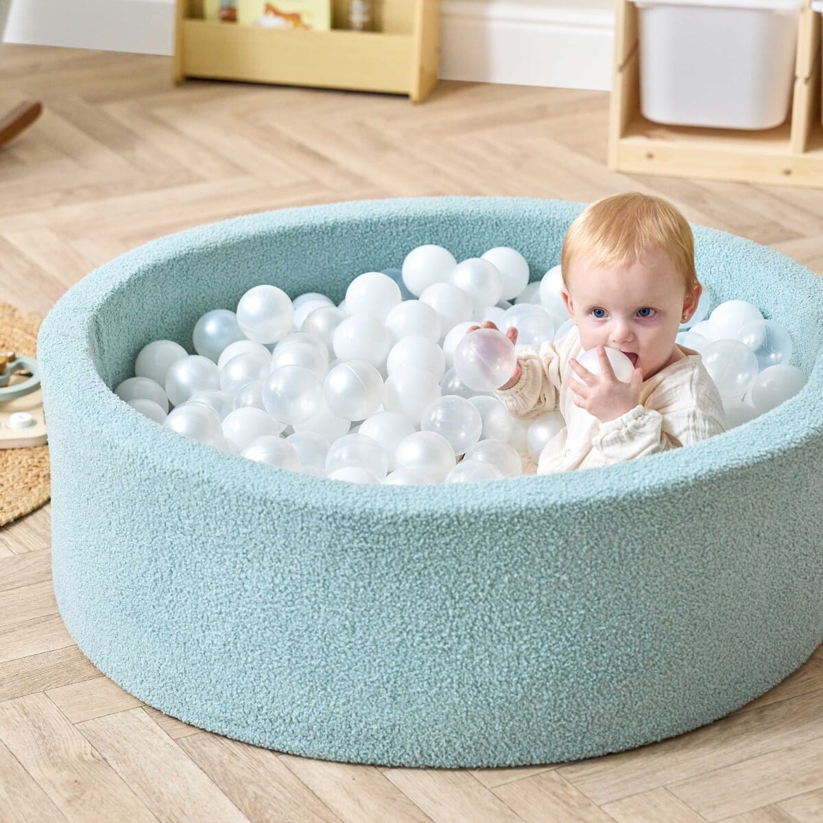 Bola Baby Ball Pit in Ocean Stone - lifestyle image of little girl playing in the ball pit