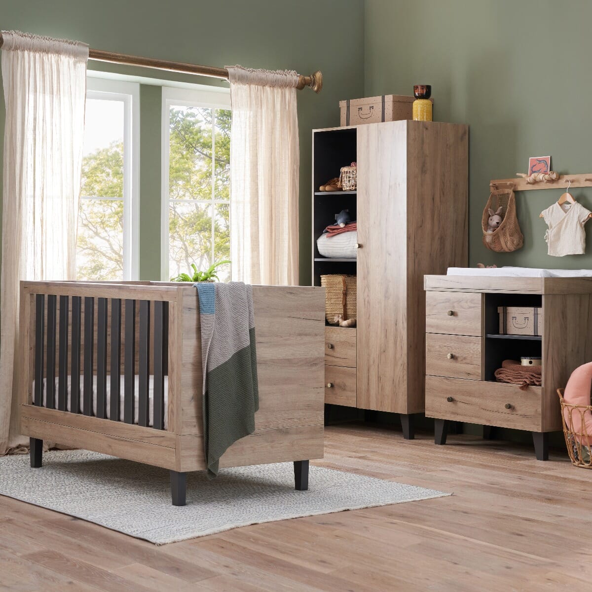 Lifestyle view of the Como 3 piece nursery furniture set in distressed oak and slate grey, featuring cot bed, chest changer, and wardrobe