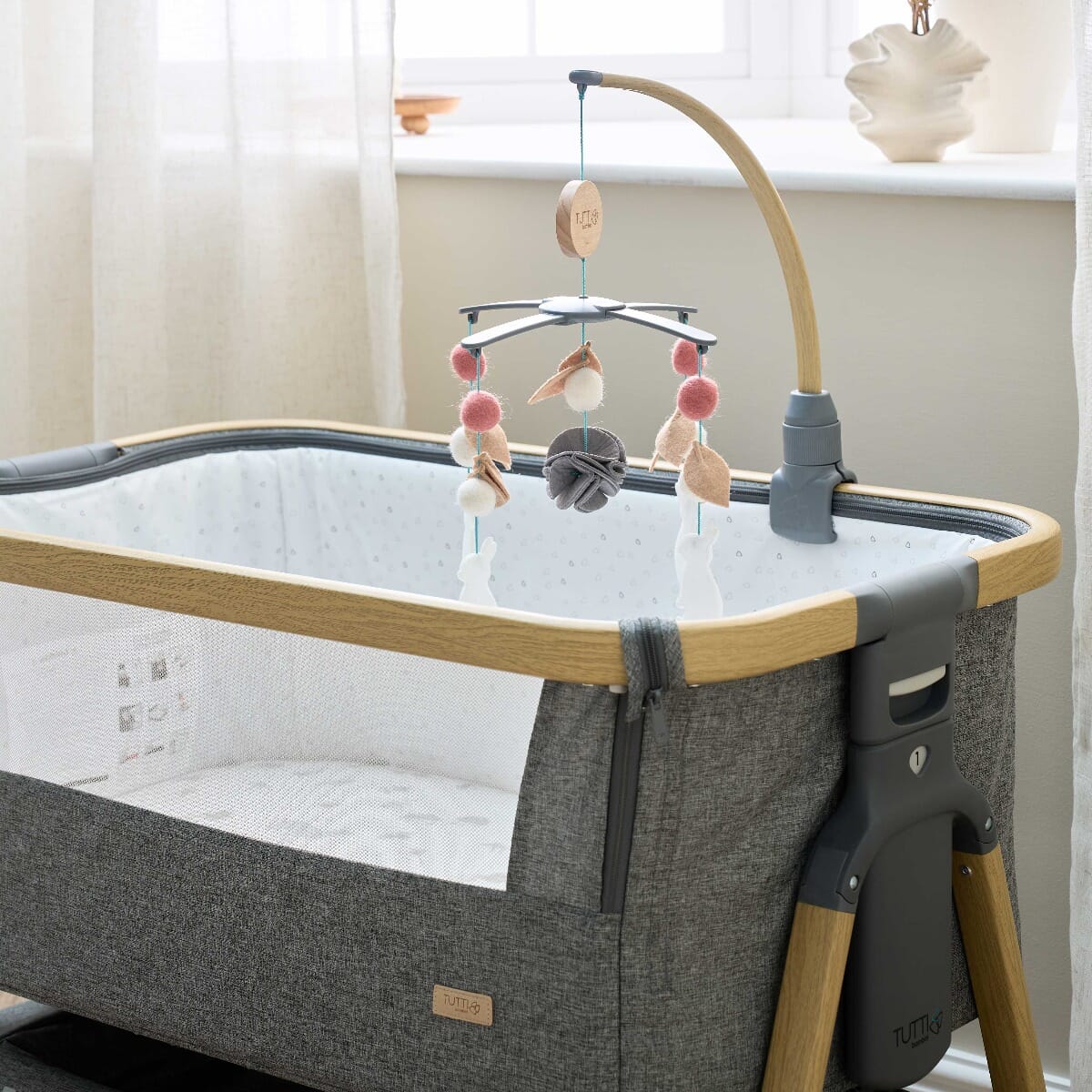 CoZee 2 in 1 Crib & Cot Mobile in Oak & Cocoon - lifestyle showing the mobile attached to the CoZee Bedside Crib