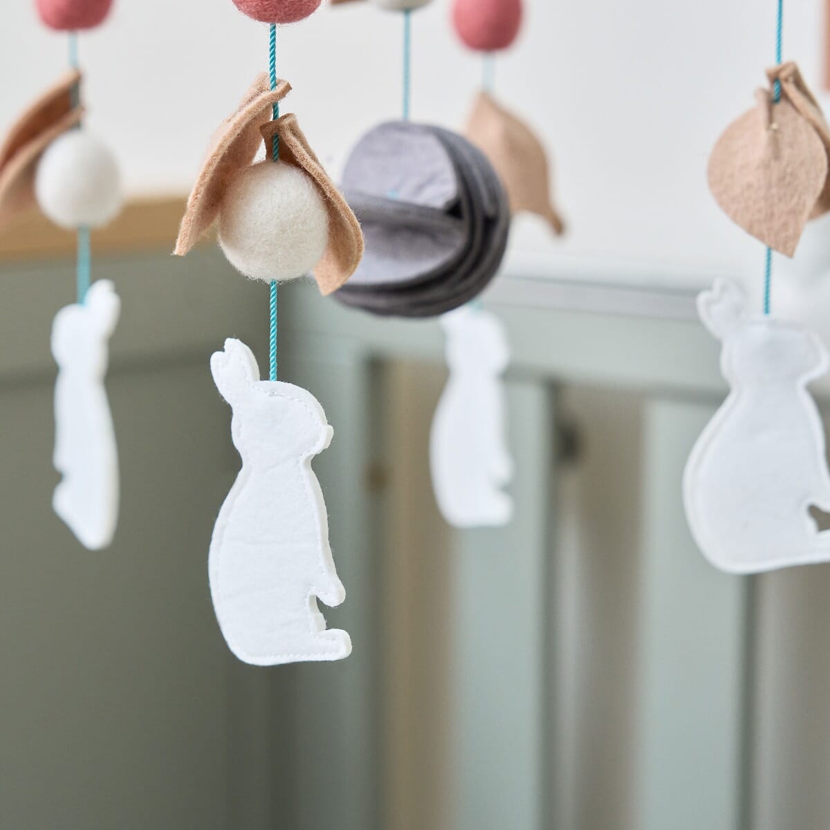 CoZee 2 in 1 Crib & Cot Mobile in Scandinavian Walnut and Cocoon - closeup on the felt details