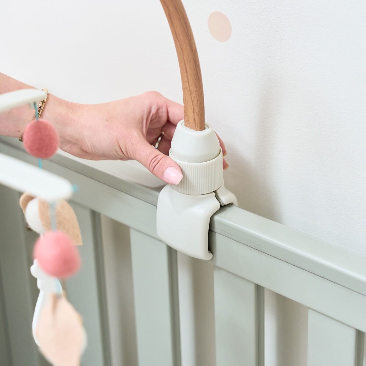 CoZee 2 in 1 Crib & Cot Mobile in Scandinavian Walnut and Cocoon - closeup on the locking mechanism for increased safety.