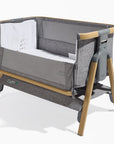 CoZee Air in Oak and Charcoal – cutout showing drop-side panel, mesh window, and rocking leg feature for soothing motion