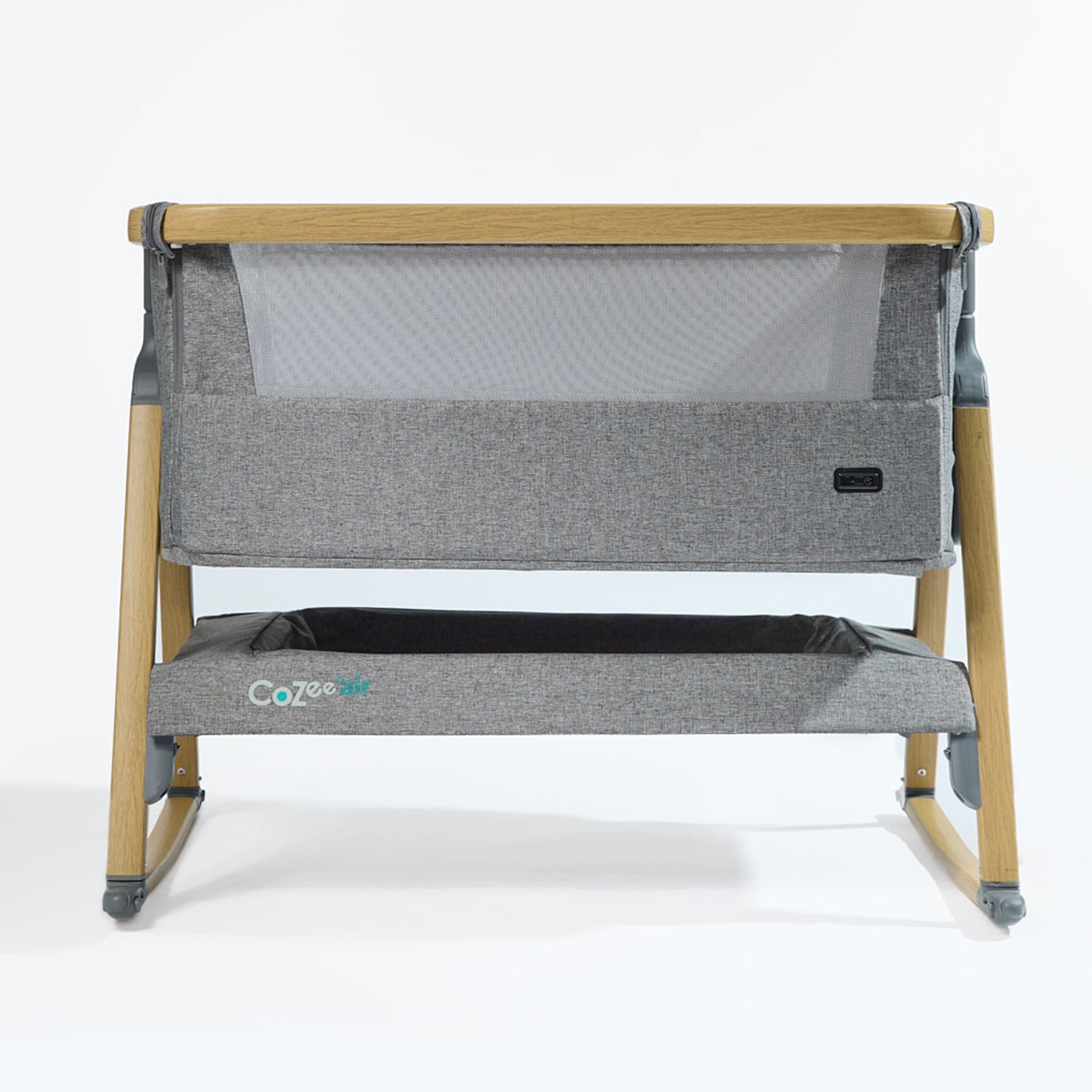 CoZee Air Bedside Crib in Oak and Charcoal – front cutout showing mesh side panel, rocking legs, and oak-effect frame