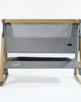 CoZee Air Bedside Crib in Oak and Charcoal – front cutout showing mesh side panel, rocking legs, and oak-effect frame