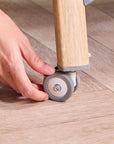 Lockable castors on CoZee Air Bedside Crib in Oak and Charcoal – smooth mobility and easy room-to-room movement