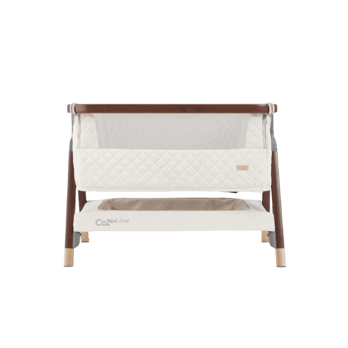 Straight-on view of the CoZee Luxe bedside crib in walnut and cream, highlighting quilted sides and mesh panel design