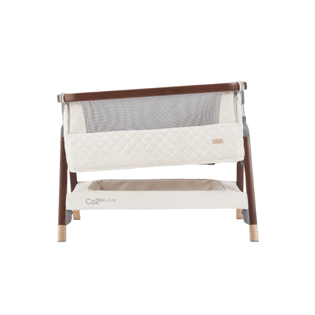 Front-facing view of the CoZee Luxe bedside crib in walnut and cream finish with incline mode shown for reflux relief