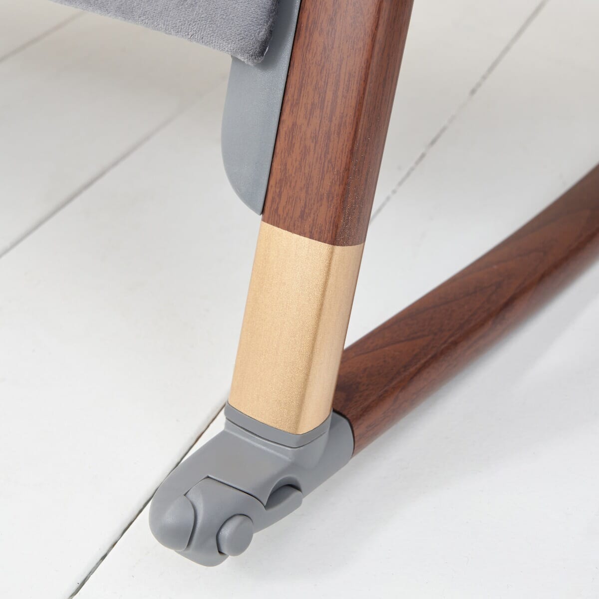 Close-up of the CoZee Luxe walnut rocking bar with wheel and stabiliser, highlighting the smooth finish and safety mechanism