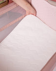 hand propping up the mattress of the cozee zen to sow its softness and padded comfort