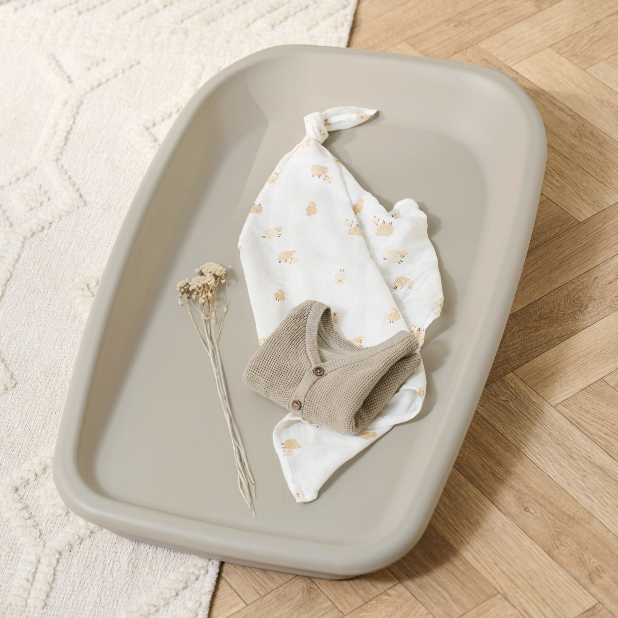 Nursery lifestyle view of the Cushi changing mat in mushroom, styled with baby essentials for a calm, practical setup