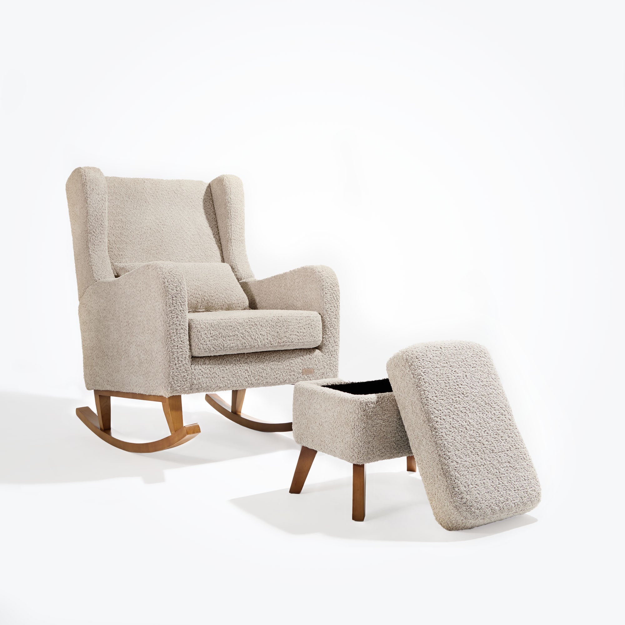 Cutout of the Harper Wingback rocking chair and footstool in teddy mushroom with footstool lid lifted to reveal hidden storage